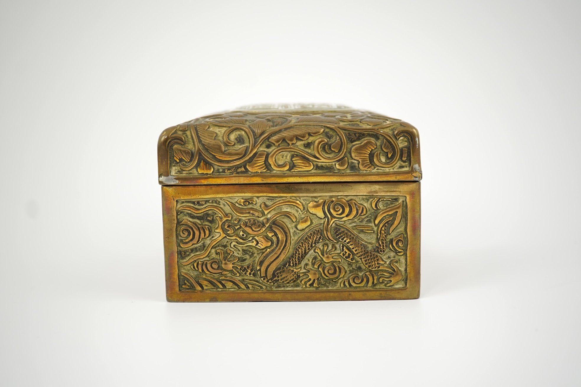 A Chinese brass 'dragon' box, inset with a 17th/18th century jade plaque